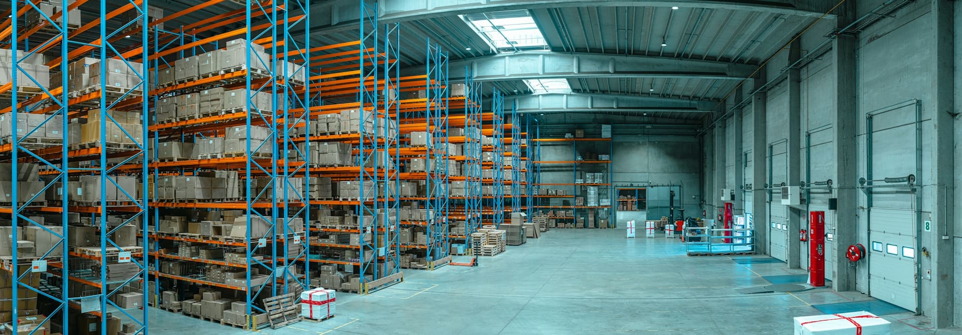 Generic materials storage warehouse with racking and organised stock areas, used as supply context imagery.