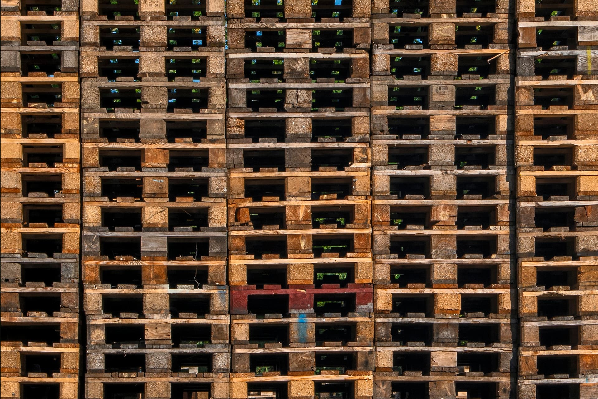 Stacked and wrapped building material pallets ready for distribution, used as bulk supply context imagery.