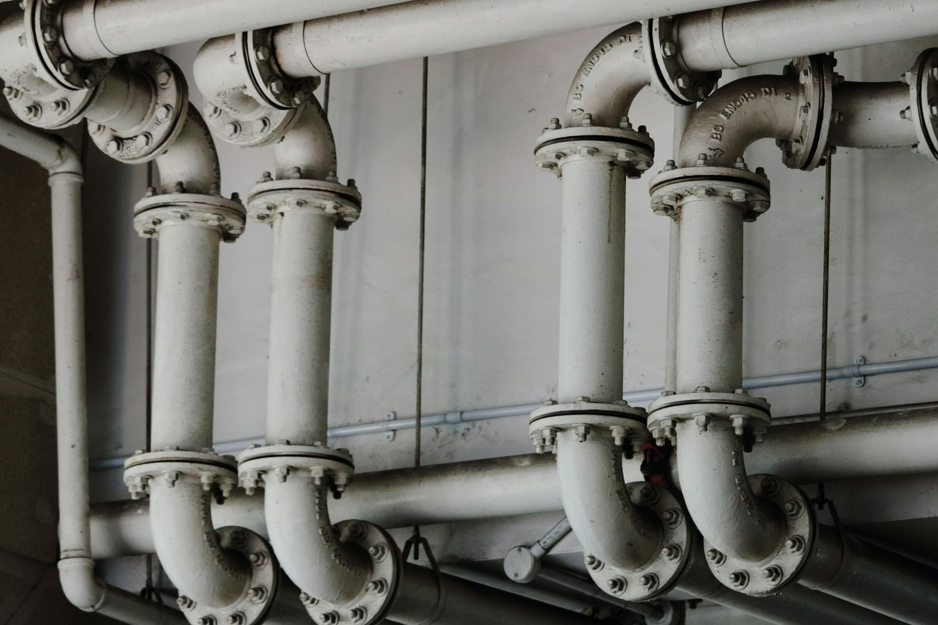Plumbing fittings and sanitary ware components, used as installation context imagery.