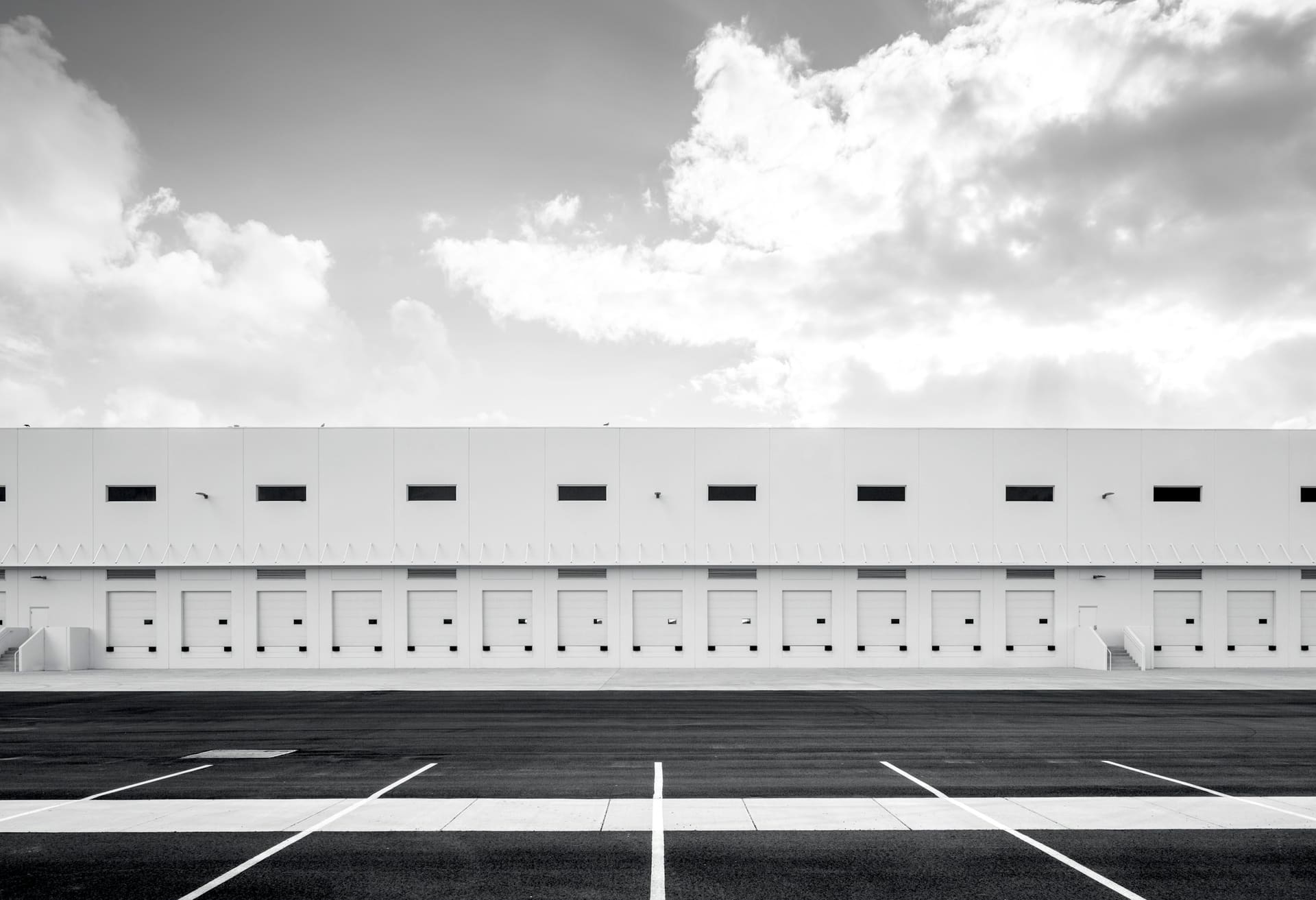 Distribution warehouse aisle with palletised goods, used as supply chain and distribution context imagery.