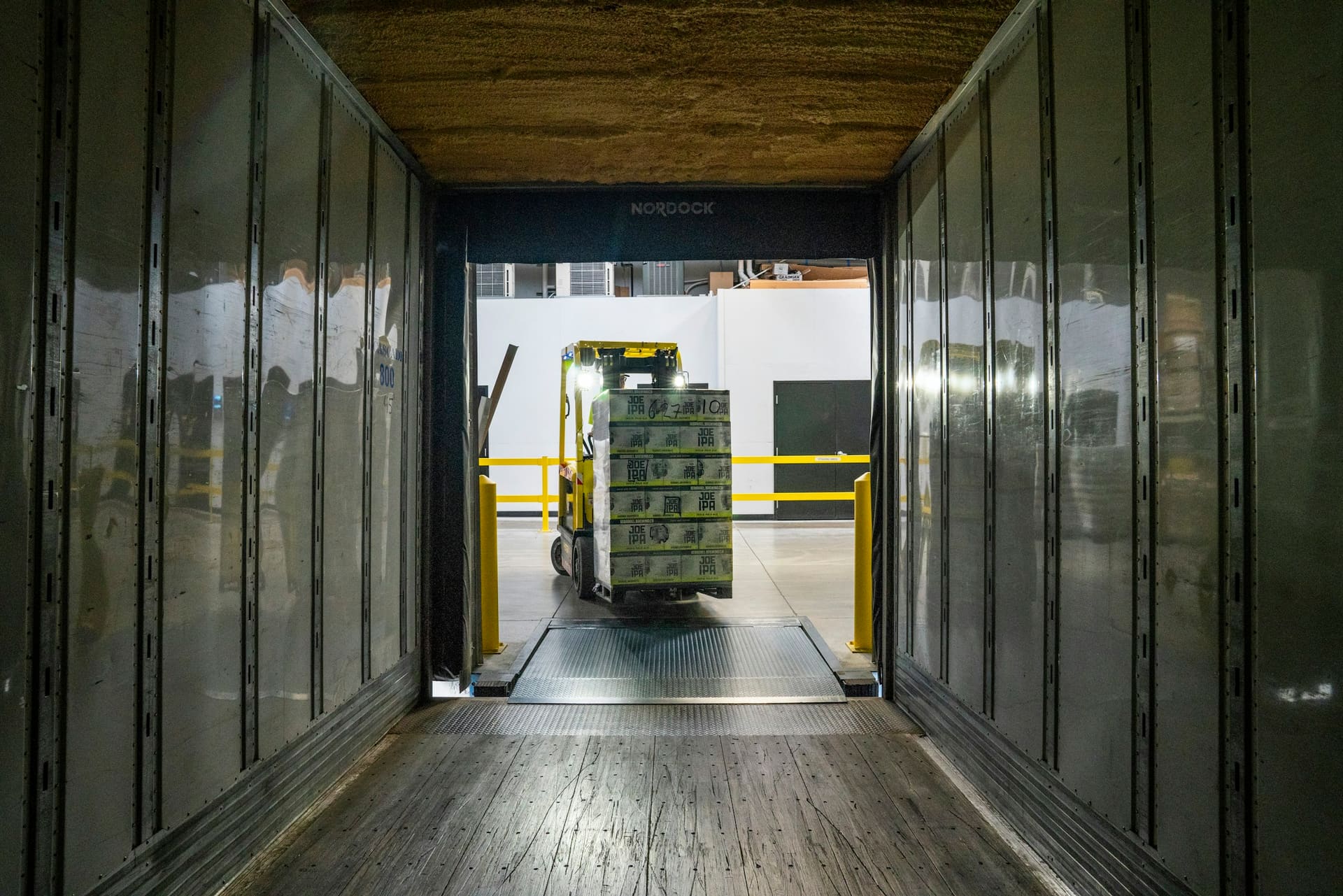 Goods being loaded for transport, used as delivery coordination context imagery.