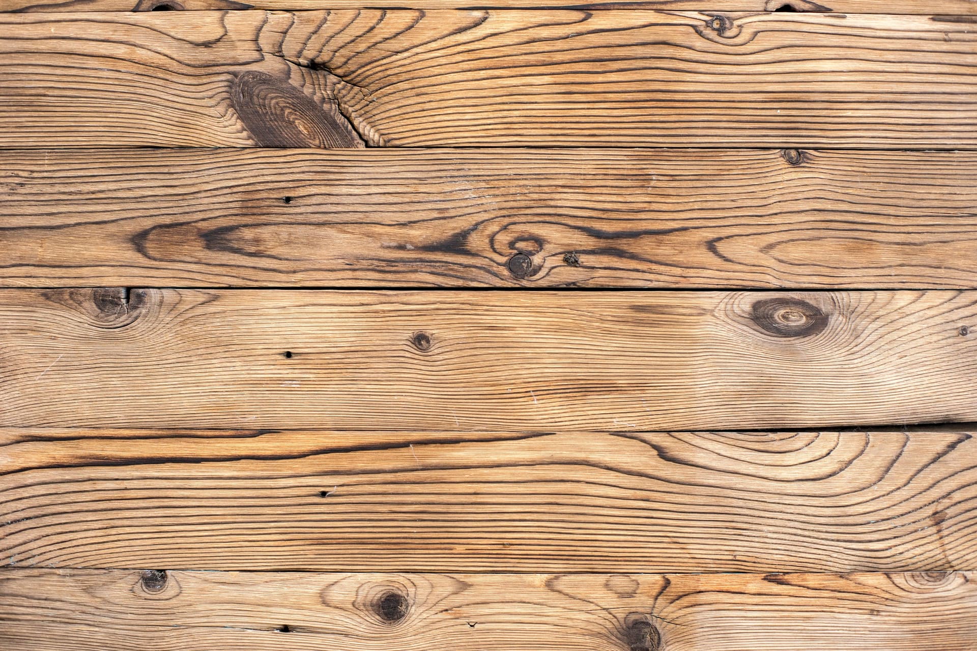 Timber planks and boards laid out showing grain and section sizes, used as product category context imagery.