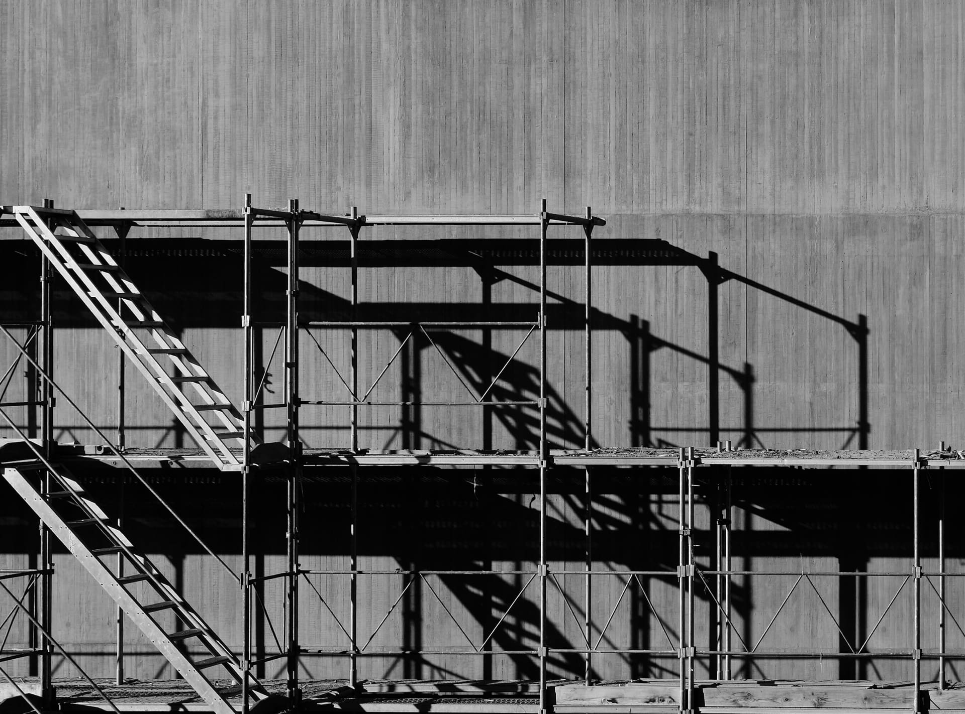 Construction site with materials staged near scaffolding, used as project supply context imagery.