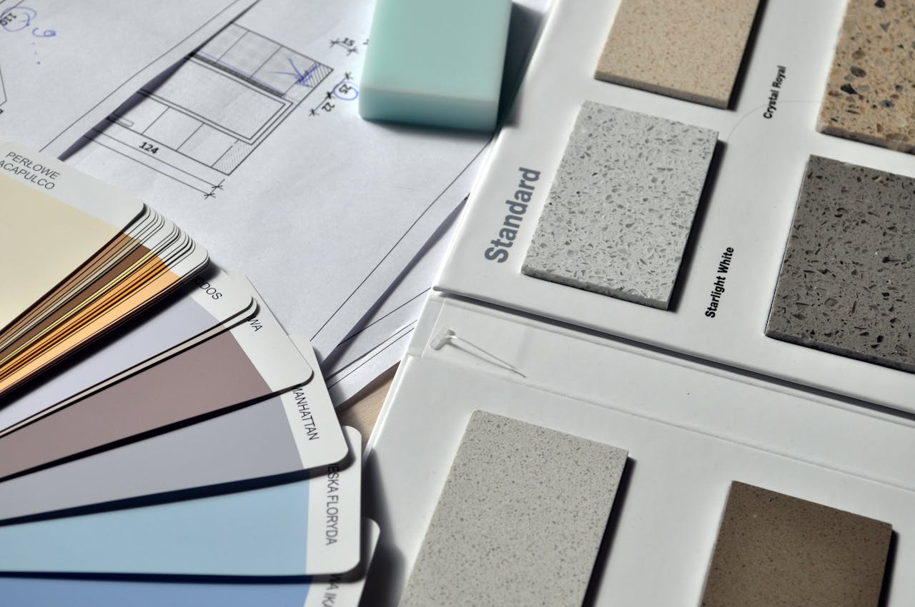 about-01 Color palette and material samples for interior renovation projects on a blueprint.